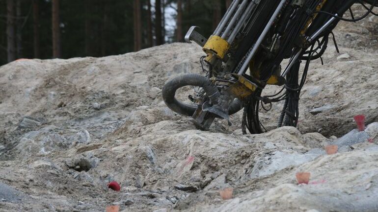 Borerigg som borer i fjell før sprengning