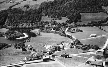 REF-0246  Voll 1953.
Sentrum av Vollagrenda med f.v. Sentralen, Bakkly, Ekre, mastu til Sentralen, Bua, Korsstuggu, Skolen, Rikstad, Svensgarden, Hurundset.
Bak ser vi Rennebu Hovudkyrkje og Hårstad Bedehus.