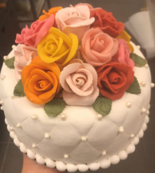 Liten marsipankake pyntet med håndlagde roser og diamantmønster.